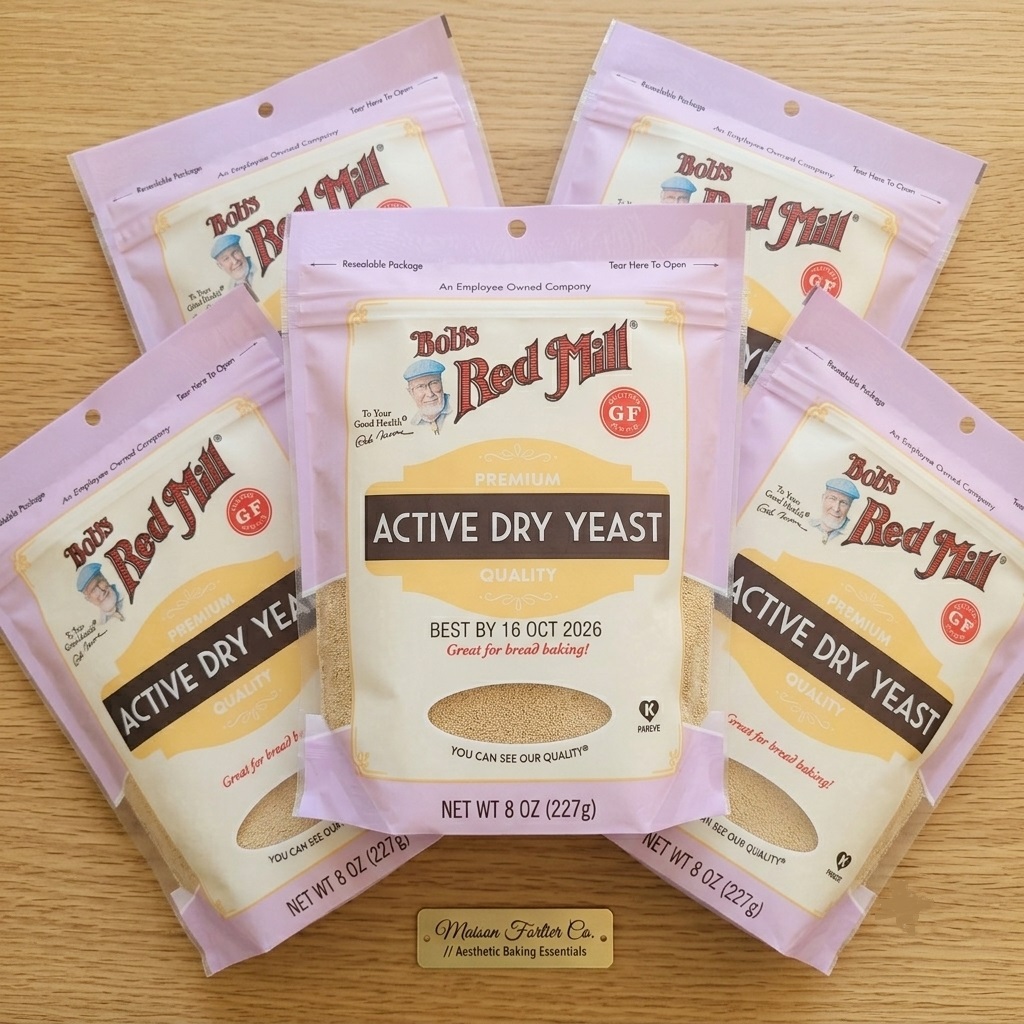 Five 8oz pouches of Bob's Red Mill Premium Active Dry Yeast on a wooden background for Maison Fortier Co.